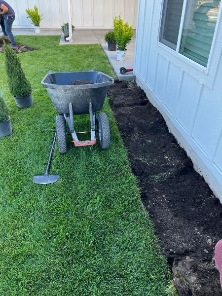 Experienced crew maintaining a healthy lawn with professional equipment on a Kalispell property