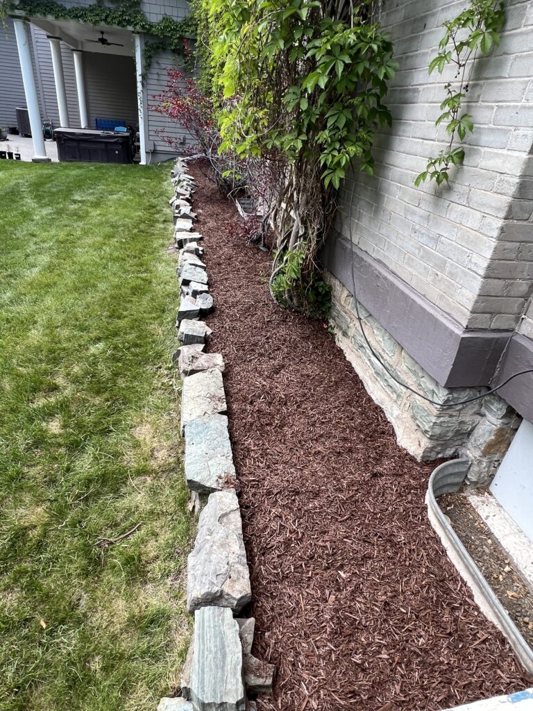 Seasonal debris removal and bed cleanup during Spring Cleaning in Somers, MT at a well-kept residential property