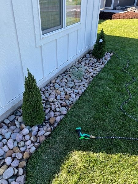 Crew designing a residential landscape with planting beds and clean borders on a Kalispell property