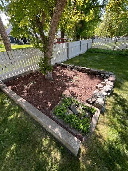 Crew designing a residential landscape with planting beds and clean borders on a Kalispell property