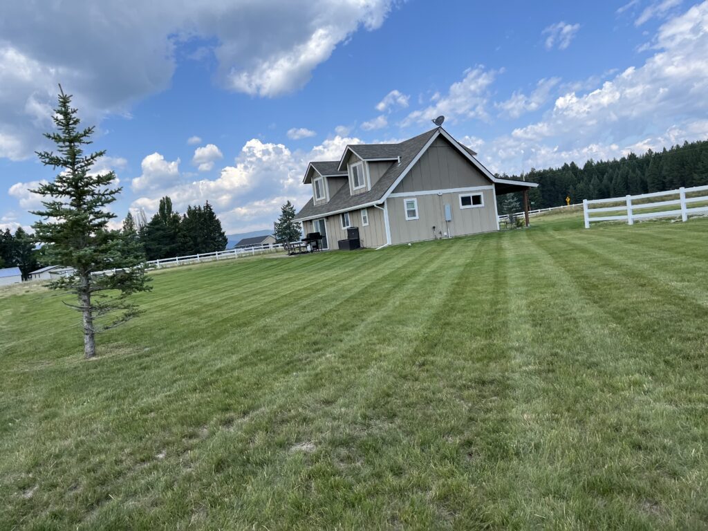 Seasonal debris removal and bed cleanup during Spring Cleaning in Bigfork, MT at a well-kept residential property